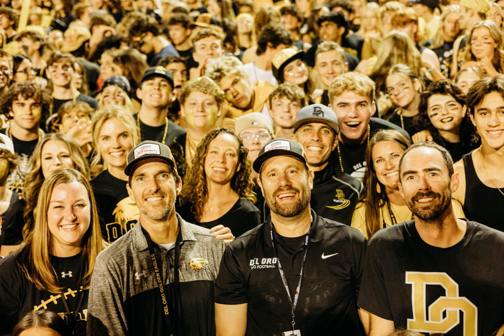 A large group of people in black shirts and hats.